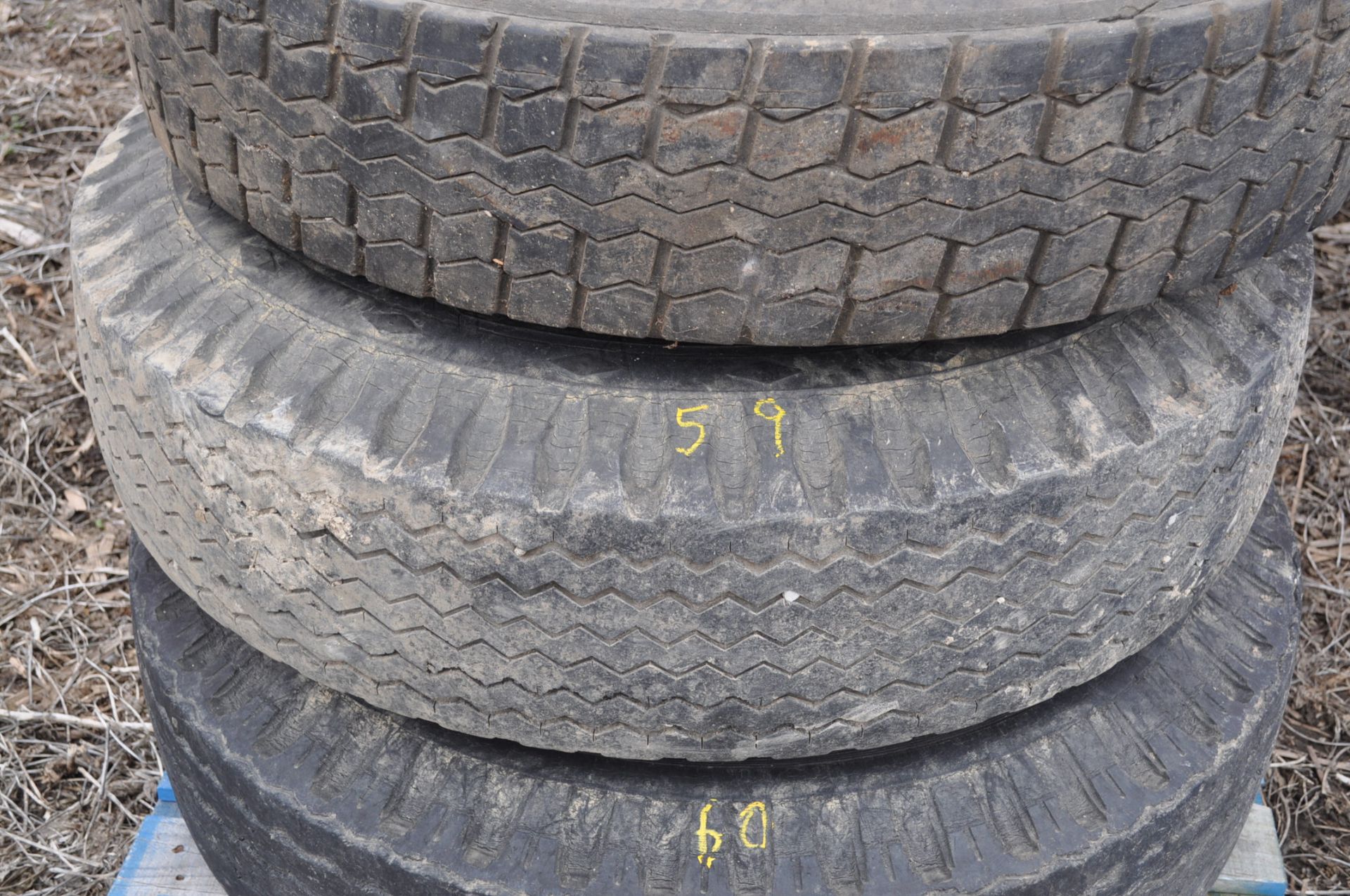 Spare 11R22.5 tire on rim for gravity wagon