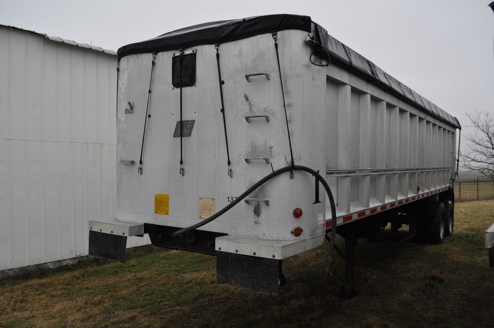 1988 East 32’ end dump trailer, spring ride, 11 R 24.5 tires, Dayton rims, roll tarp, coal chute,