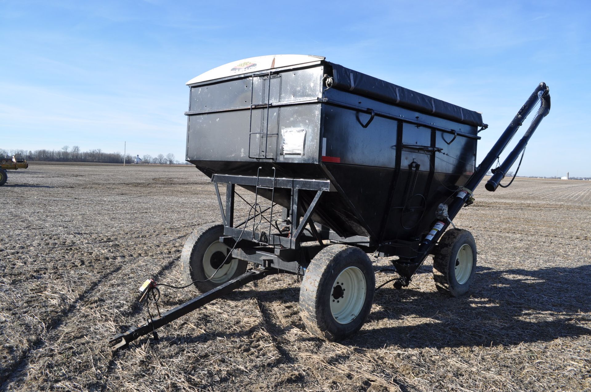 300 bushel gravity seed wagon, 15’ J & M poly cup auger, Auger Mate hyd power unit, 295/75 R 22.5