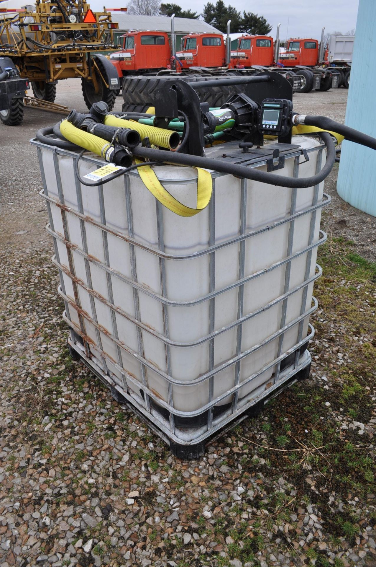 poly chemical tank in cage with 12 volt pump and meter