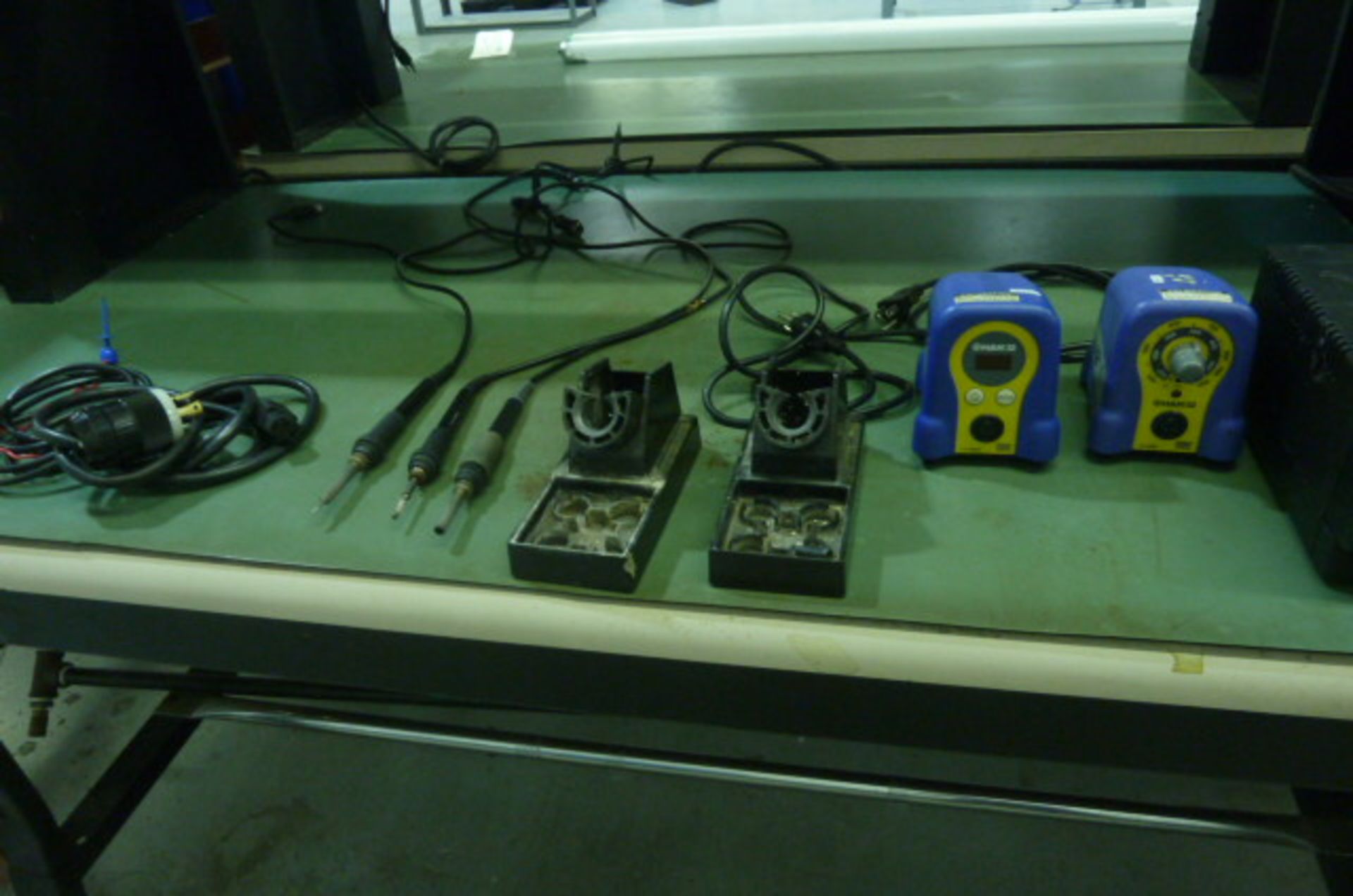 Two Aoyue's, 2) Hakko's, and 3) stencil holders