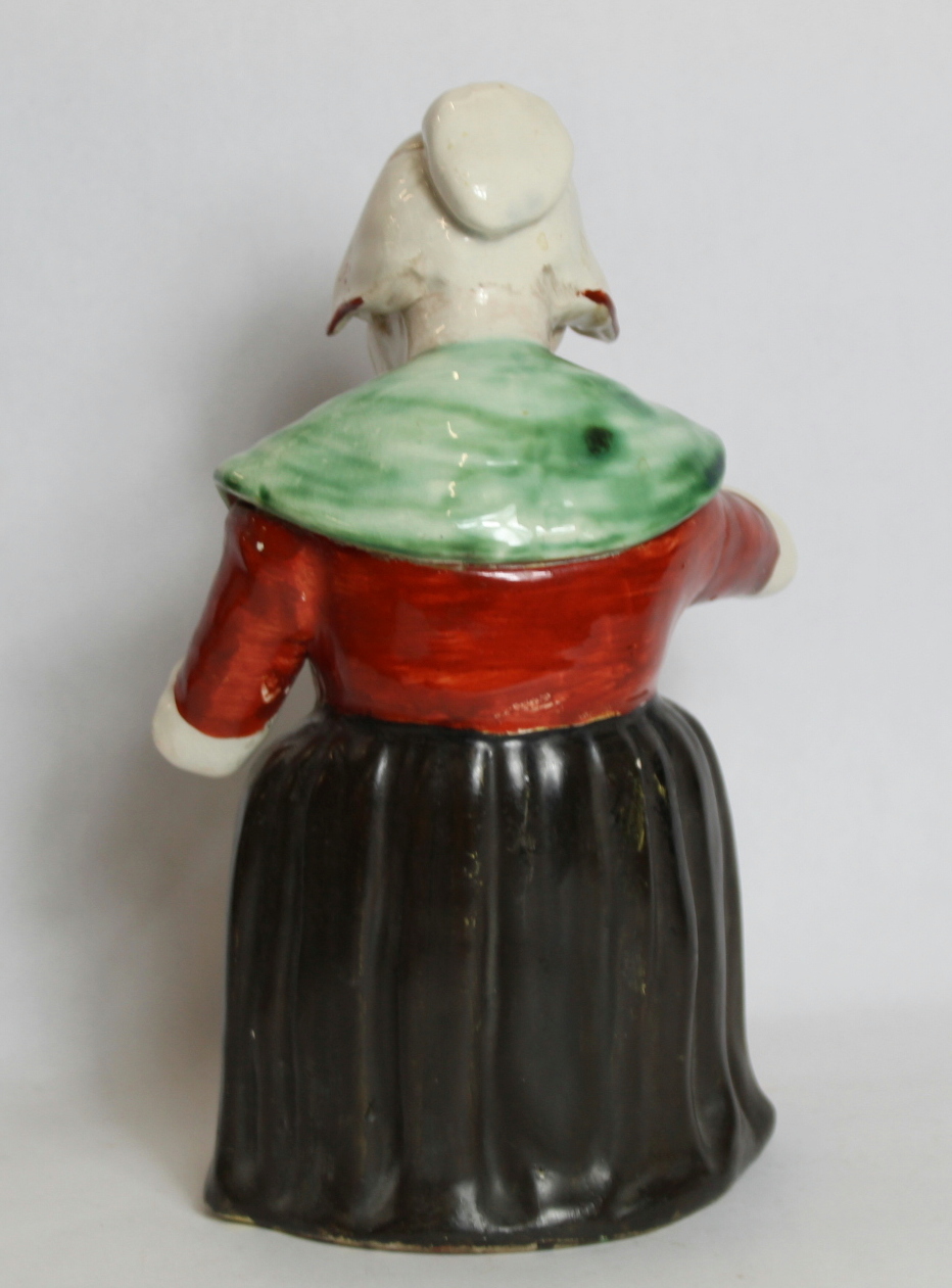 19th century pottery figure of a woman taking snuff, decorated in polychrome, 28cm high. - Image 2 of 3