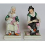 Pair of 19th century porcelain figures of a cobbler and his wife seated on a square plinth base