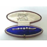 Edwardian bar brooch with two pearls and three diamonds in gold fronted with platinum.
