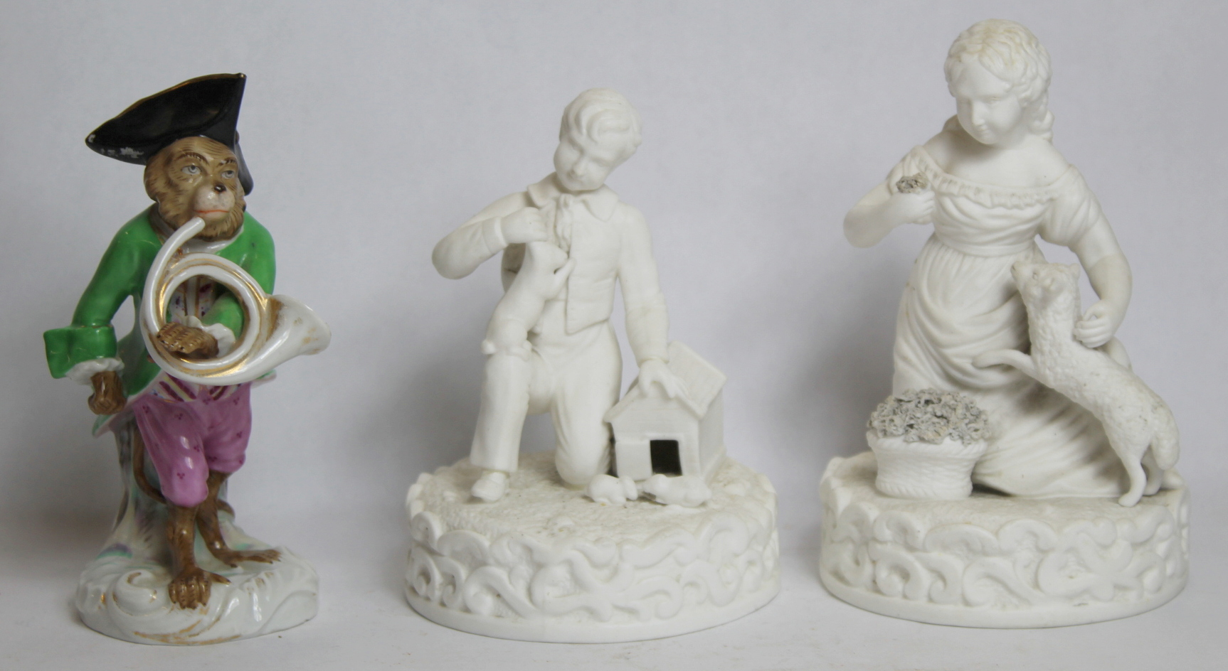 Two small Victorian or Edwardian Parian figures of a boy with pet rabbit and a girl with pet lamb,