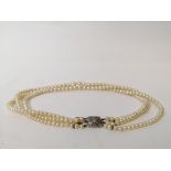 Three strand cultured pearl necklace, on French white gold snap with diamonds.