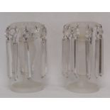 Pair of frosted glass table lustres with cut flowerhead and petal decoration, baluster columns and