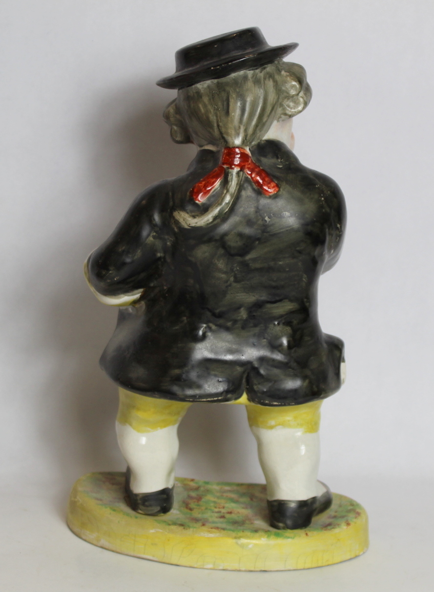 19th century pottery figure of a man taking snuff, standing on a kidney shaped plinth base, - Image 2 of 4