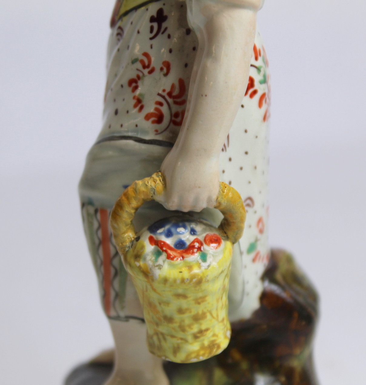 19th century pearlware figure of a farm girl carrying a basket of flowers, on square plinth base - Image 6 of 8