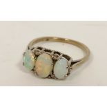 Opal three stone ring with eight cut diamonds in 18ct white gold, 1975. Size 'N'.
