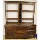 Antique oak dresser, the later open back with central shelves, the base fitted with three central