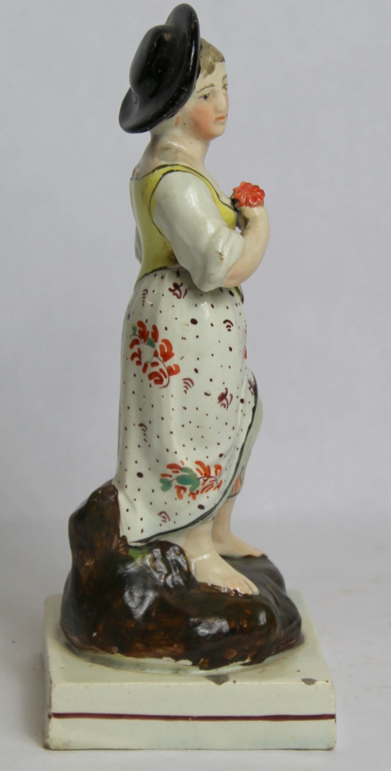 19th century pearlware figure of a farm girl carrying a basket of flowers, on square plinth base - Image 2 of 8
