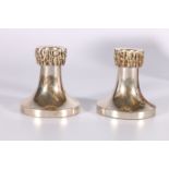 Pair of silver dwarf candlesticks of tapering shape with detachable drip sockets, Mercers' Crest.
