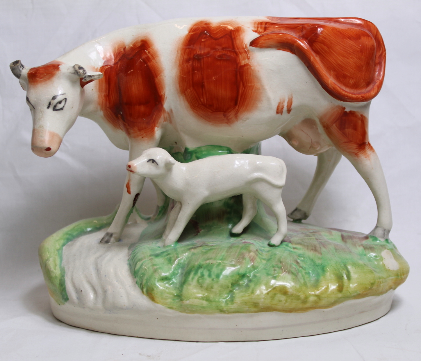 19th century Staffordshire pottery figure of a red and white cow and calf, on naturalistic oval - Image 2 of 7