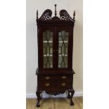 Reproduction display cabinet the pierced swan neck pediment over a pair of astragal glazed doors