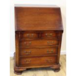 Reproduction mahogany  bureau, the fall front enclosing fitted interior over two short and three