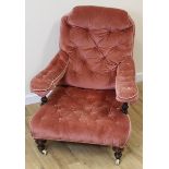 Victorian Howard style button back open armchair raised on turned supports.