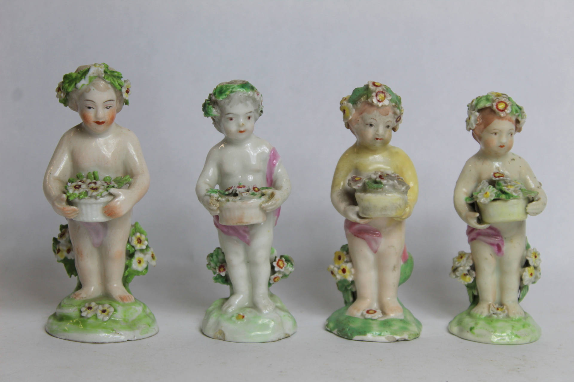 Seven 18th century Derby porcelain small figures of putti holding baskets of flowers, all with patch - Image 6 of 9