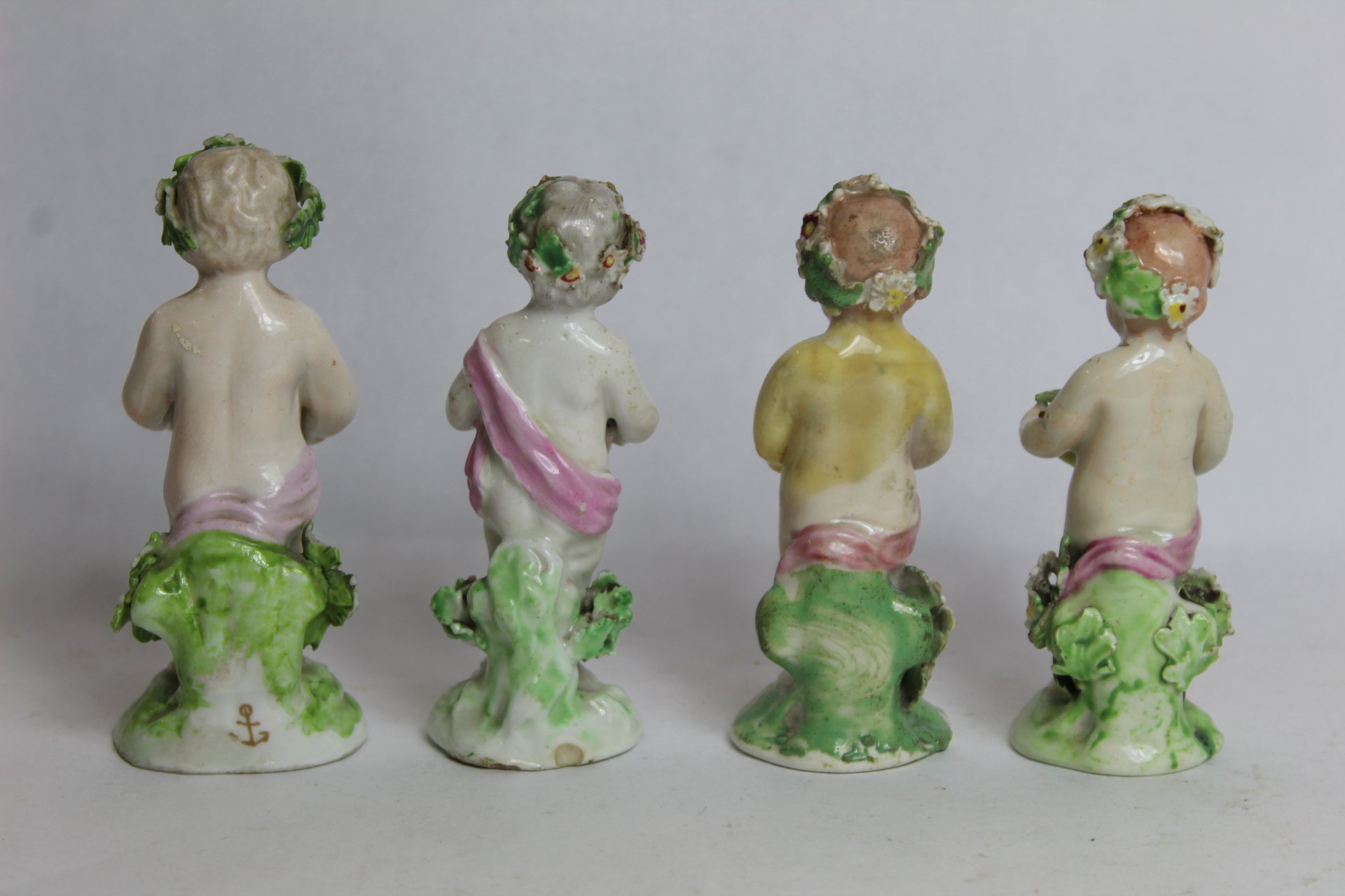 Seven 18th century Derby porcelain small figures of putti holding baskets of flowers, all with patch - Image 7 of 9