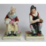 Pair of 19th century Staffordshire pottery figures of a cobbler and his wife decorated in polychrome