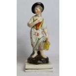 19th century pearlware figure of a farm girl carrying a basket of flowers, on square plinth base