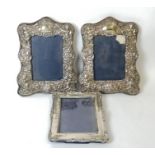 Pair of photo frames with embossed silver mounts, for images 14cm x 9cm, and another 13cm x 9½cm.
