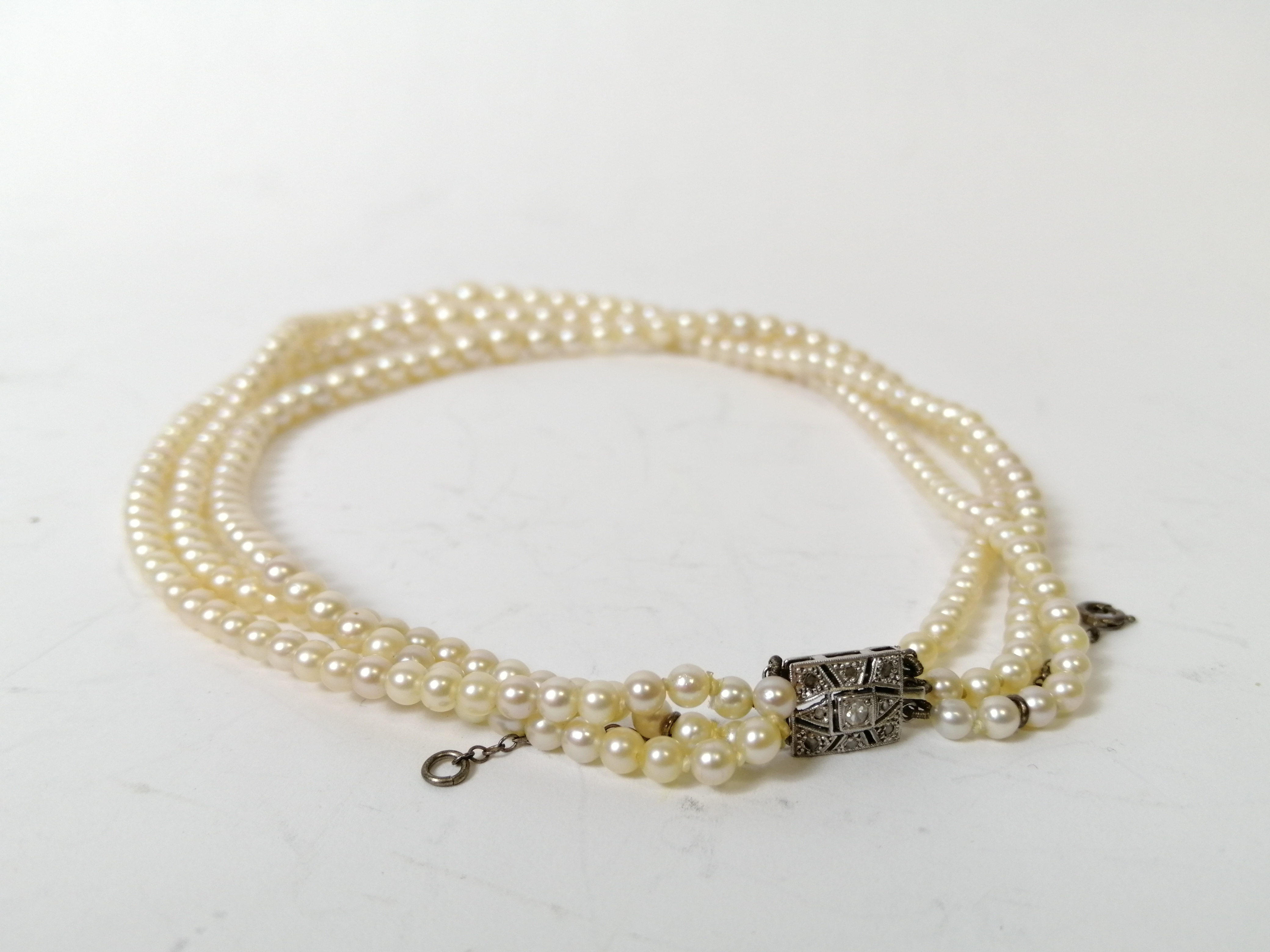 Three strand cultured pearl necklace, on French white gold snap with diamonds. - Image 3 of 5