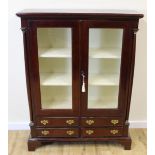 Reproduction mahogany bookcase cabinet enclosed by pair of glazed doors over four drawers. 98cm