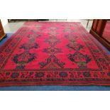 Large Turkish wool on wool carpet, the tomato red field with three rows of five hooked