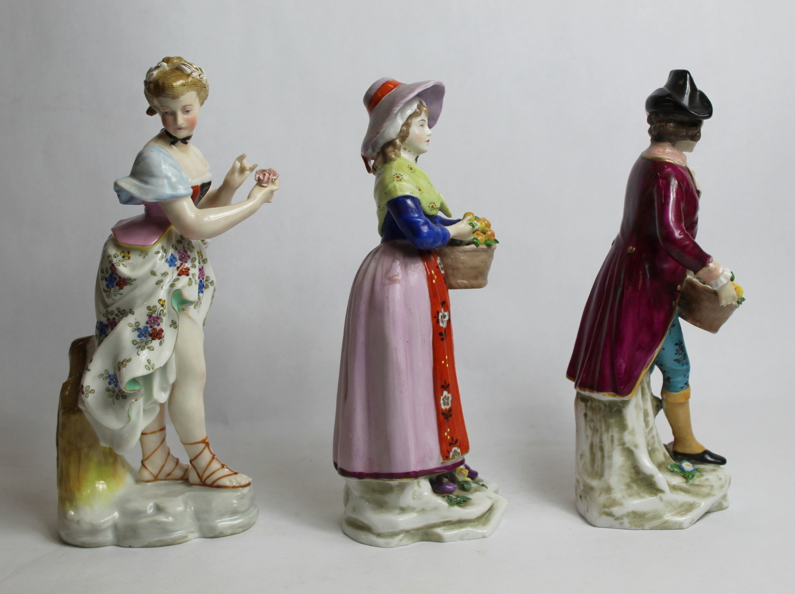 Two continental porcelain figures of fruit sellers, each holding a basket of apples, each 21cm - Image 4 of 14