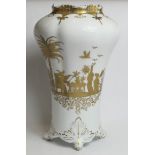 19th century opaque milk glass vase of lobed baluster form, with four foliate scroll feet and gilt