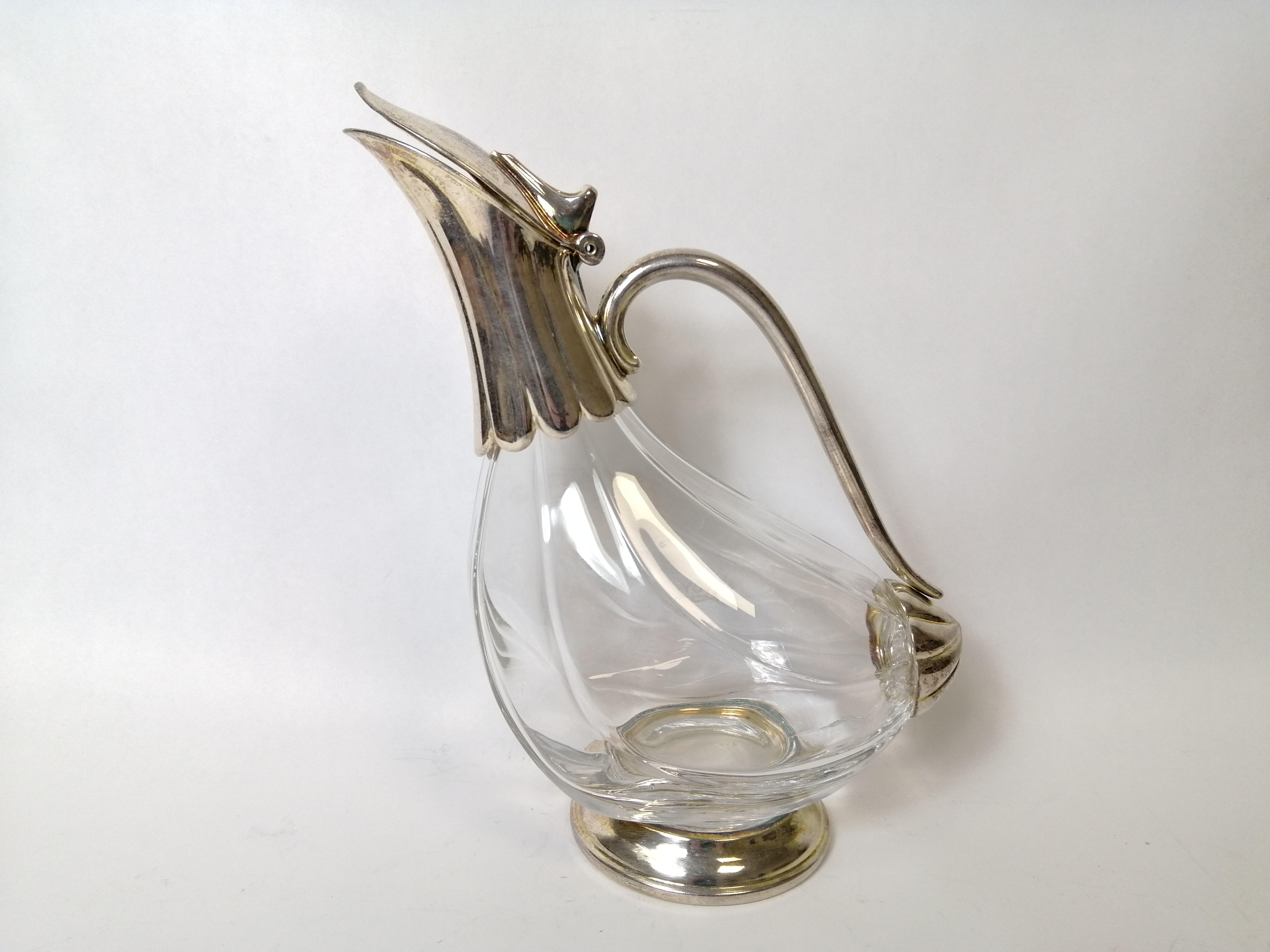 Glass claret ewer of bird shape with e.p. mounts, inscribed 'Savoy'.