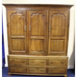 Antique oak press cupboard enclosed by three panel doors over three dummy drawers with drawers