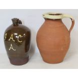 Treacle glazed stoneware flagon of pushed in baluster form with single scroll handle, inscribed with