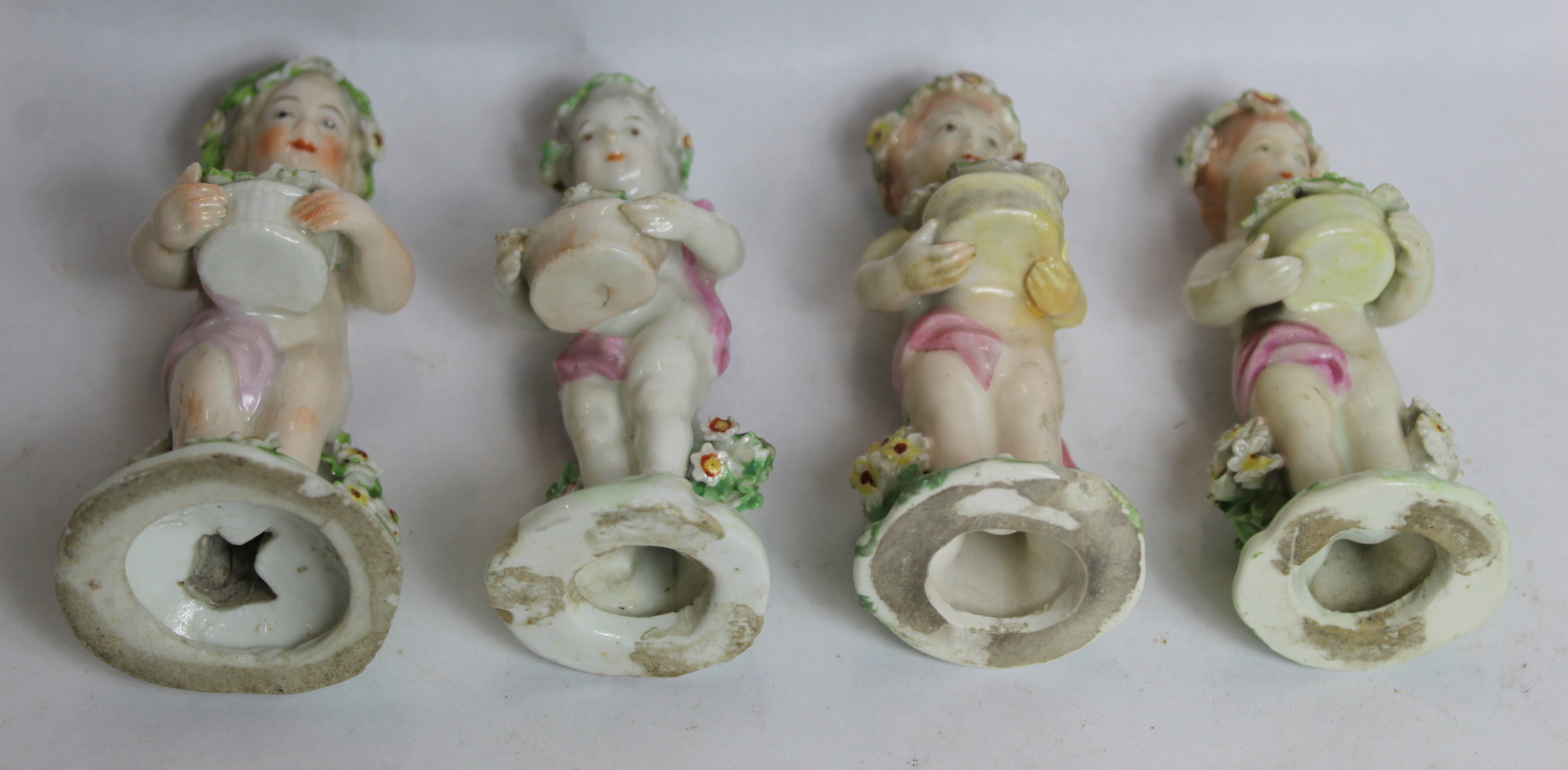 Seven 18th century Derby porcelain small figures of putti holding baskets of flowers, all with patch - Image 9 of 9