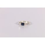 Three stone ring with square sapphire and two diamond brilliants each approx. .25ct in white gold.