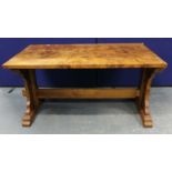 Burr walnut extending dining table with two additional leaves above stretcher base.