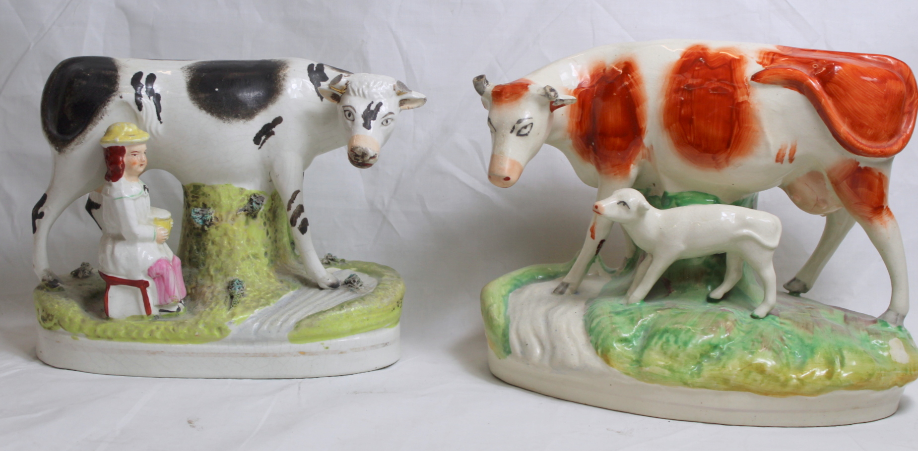 19th century Staffordshire pottery figure of a red and white cow and calf, on naturalistic oval