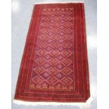 Kurdish rug with all over diamond design, red ground and multiple border, 186cm x 97cm.