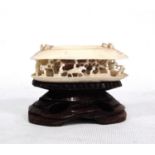 19th century ivory netsuke of a mussel shell partly open revealing a village scene, 7cm wide.