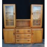 Ercol sideboard cabinet with central open shelf flanked by glazed doors, rectangular top, three long