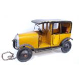 1930s Lines Brothers Tri-ang wooden model of a taxi in yellow and black, 47cm long and 27cm high.