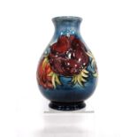 Moorcroft 'Anemone' baluster vase by Walter Moorcroft with line decorated over faded blue ground,