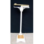 Set of scales with brass rule and weight, on cast iron pedestal and plinth base, 125cm high.
