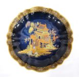 Carlton Ware lustre tazza with scalloped edge, gilt floral decoration, the centre with pagoda and