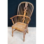 Windsor chair, the comb back with carved pierced central splat, hoop arms, baluster turned