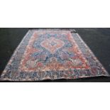 Meshed carpet with central medallion over blue ground, all over floral design, spandrels and