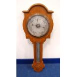 Late 19th century or early 20th century oak barometer, the moulded arched pediment over brushed