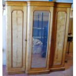 Victorian satinwood breakfront wardrobe, the projected moulded cornice over mirrored door flanked by