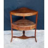 Regency mahogany corner stand with bowfronted top over open shelf, boxwood strung frieze drawer